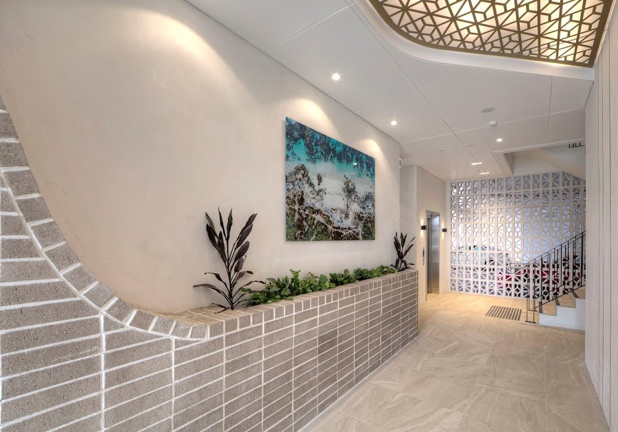 Painted commercial foyer with feature ceiling and tiled feature wall